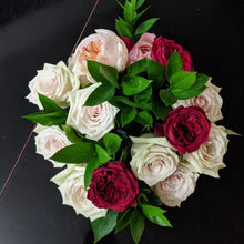 Ruscus arranged with pink and red roses
